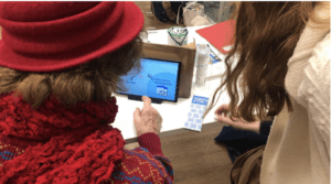 Image of someone demonstrating how to use the prototype at a community group