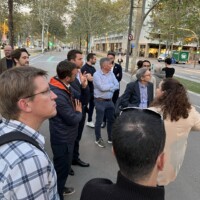 An image of a group of people looking to the right as part of a walking tour of the innovation district in Barcelona