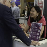 A photo of Polly from the LOTI team speaking to someone at the LOTI stand