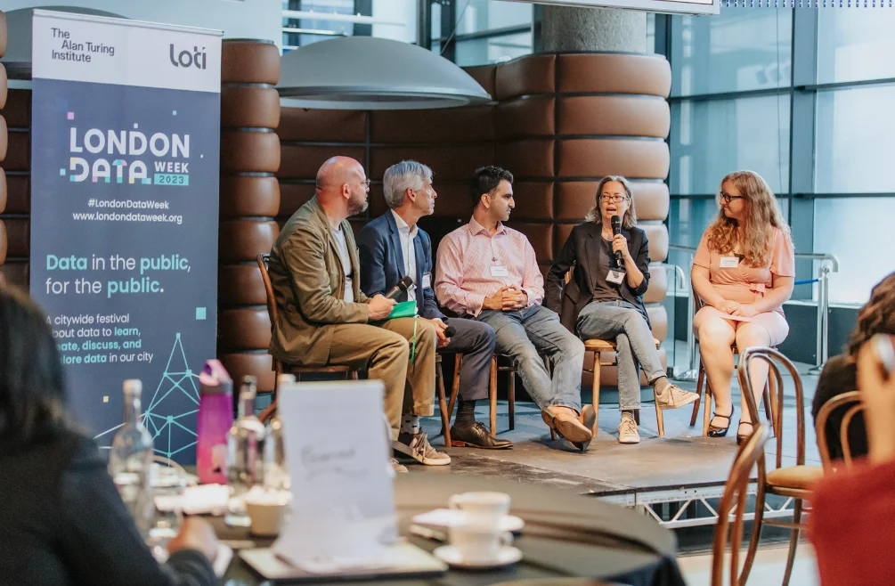 Panel discussing 'Why is London's data innovation unique?'. From left to right Theo Blackwell MBE (Chief Digital Officer for London), Kirstie Whitaker (Programme for Tools, Practices and Systems, The Alan Turing Institute, Louise Crow (Chief Executive at mySociety), Omid Shiraji (Consultant Chief Information Officer), Russ Shaw (Founder, Tech London Advocates & Global Tech Advocates)