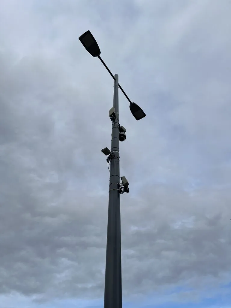 Lamp column with sensors against the backdrop of the sky