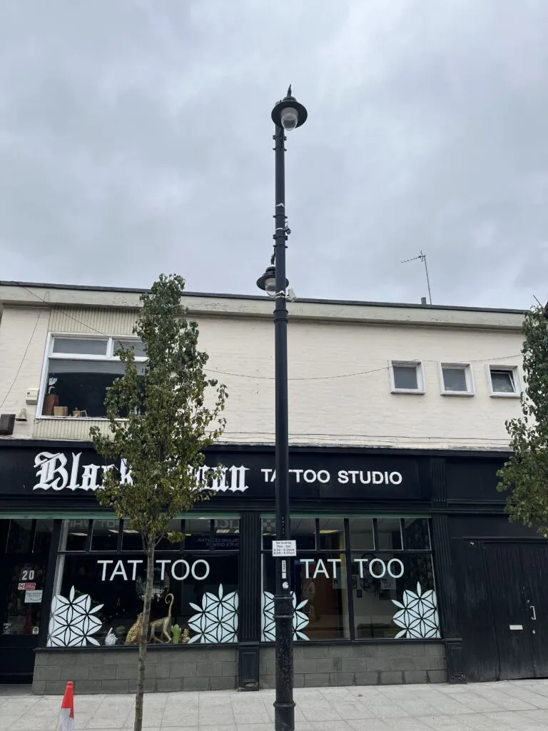 lamp column with sensors in front of tattoo studio