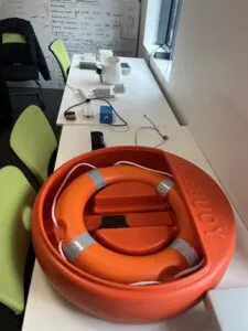 A table with a display of various IoT devices, including a life buoy and other sensors