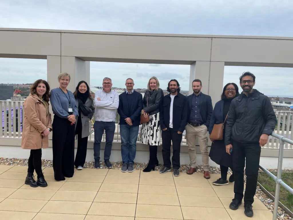 The LOTI delegation standing on the roof of Sunderland City Council's office with the Stadium of Light in the background, photo taken by Boldyn Networks
