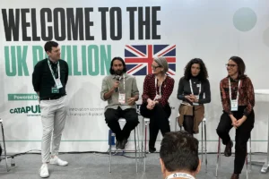 A photo of Jay Saggar from the LOTI team speaking in a panel of five people at the UK pavilion at the Smart City Congress in Barcelona